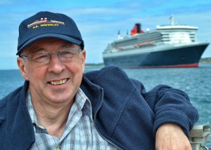 Maritime author Peter Elson aboard a St. Peter Port tender with Cunard's flagship Queen Mary 2 moored in the background