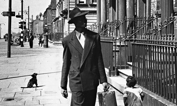 An immaculately attired West Indian man looks for accommodation among the tall townhouses in Liverpool's Parliament Street, 1949